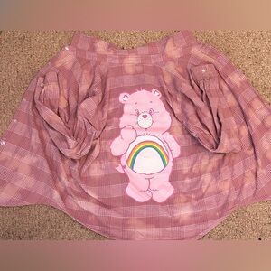 Pink button up shirt with care bear.